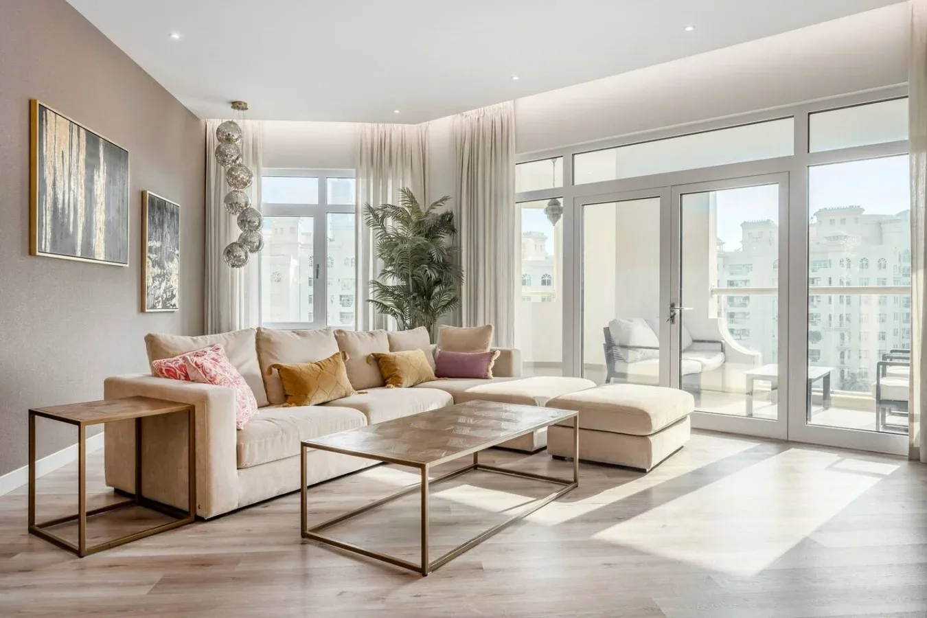 A bright living room with sectional seating and large windows.