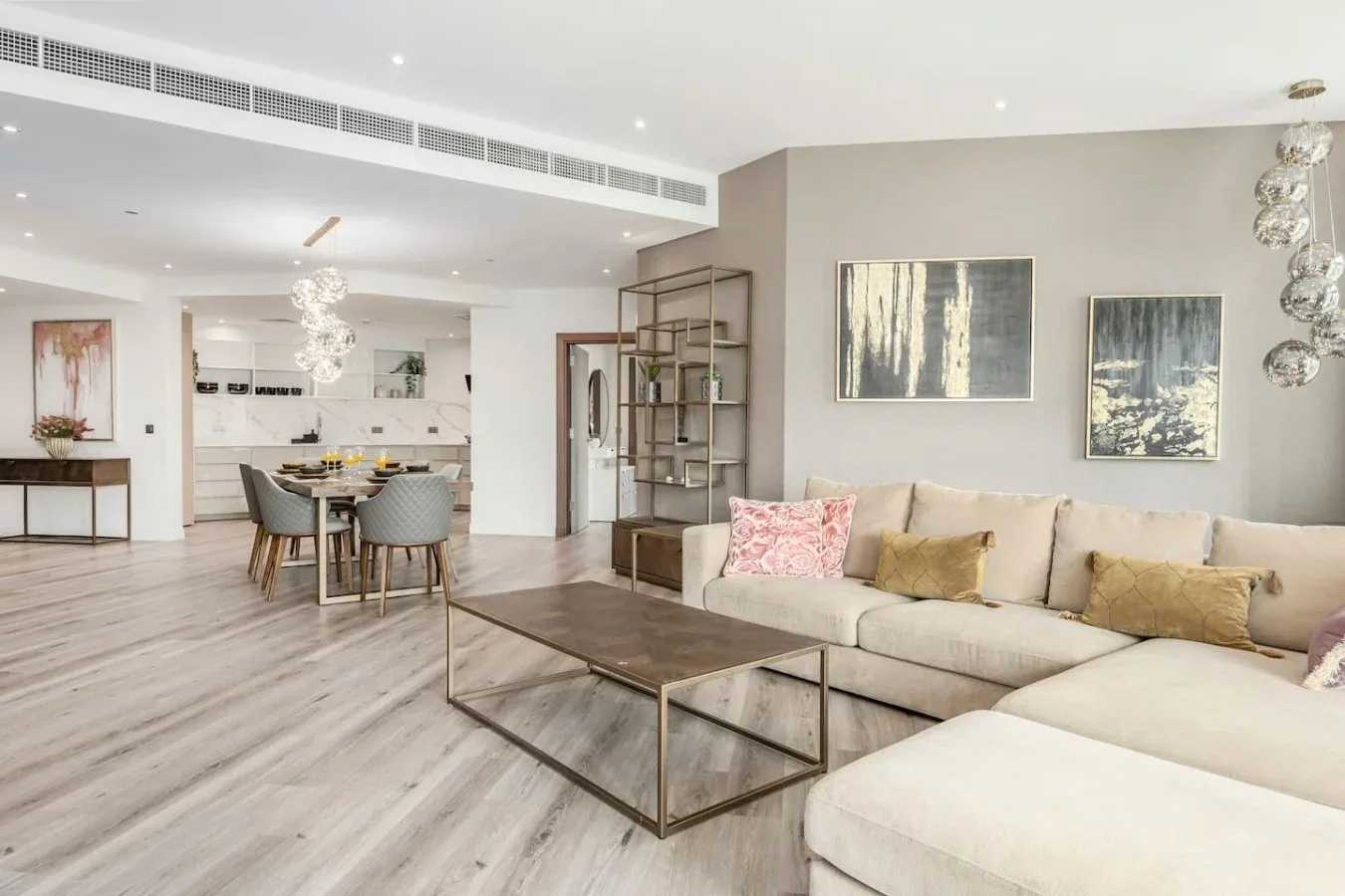 An open-plan living and dining area with a sectional sofa and dining table.