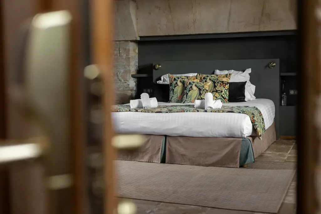 Deluxe hotel bedroom with stone vaulted ceiling