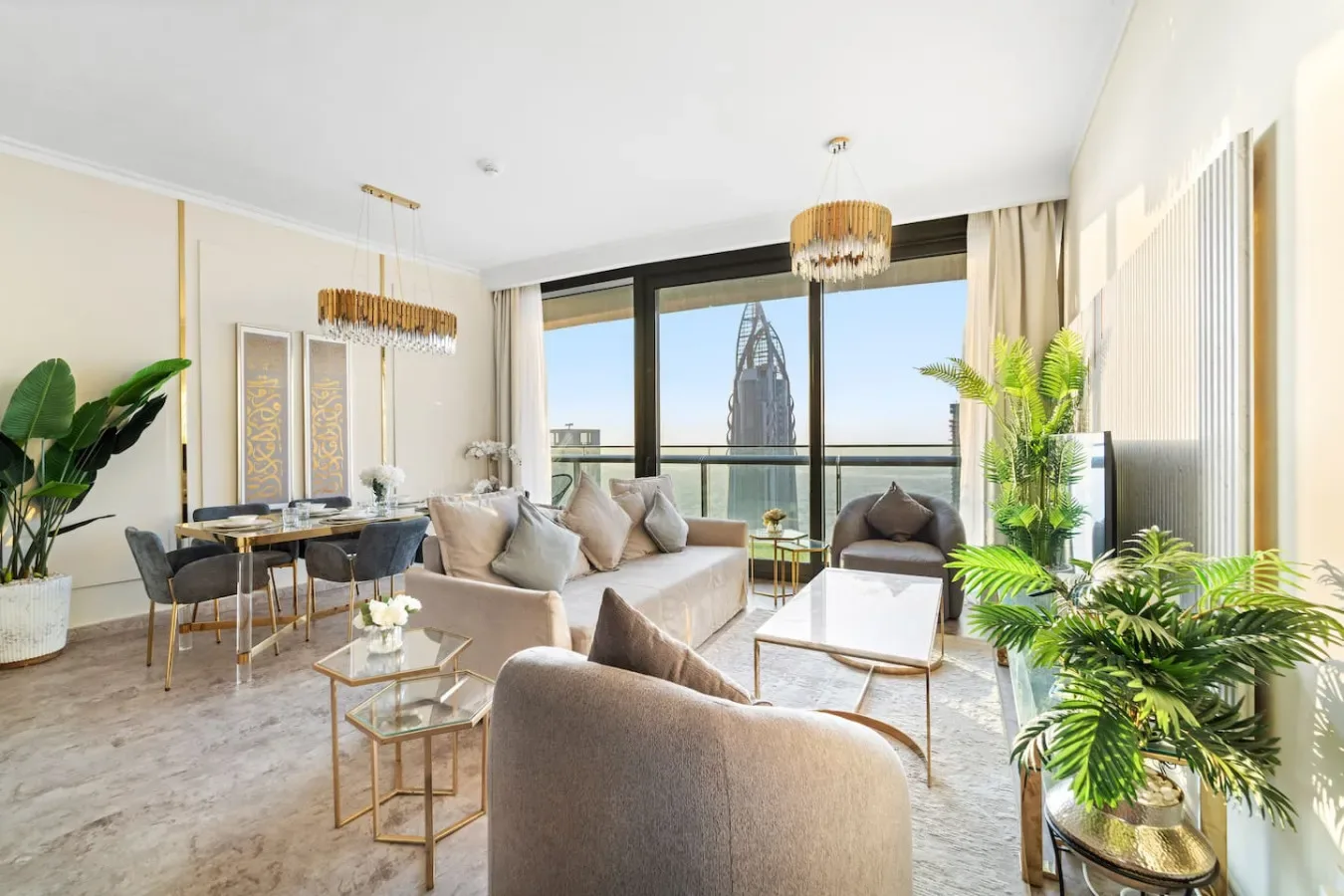 A bright living room with seating, a dining area, and large windows.