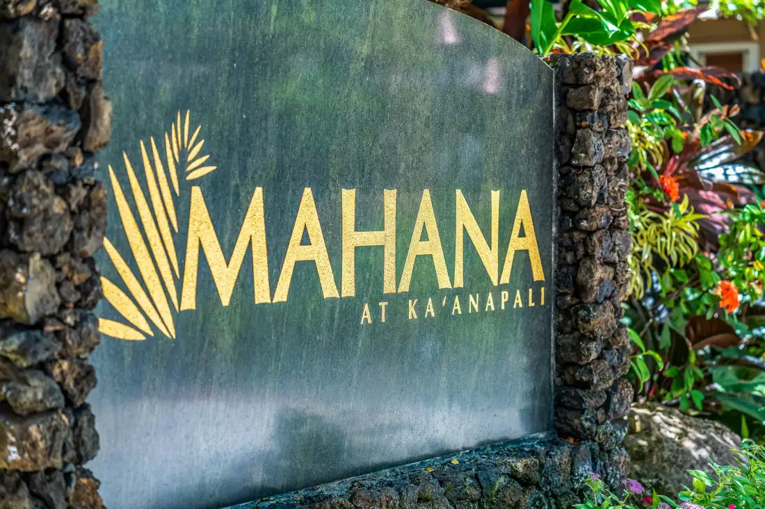A landscaped entrance sign displays the name Mahana at Ka'anapali.