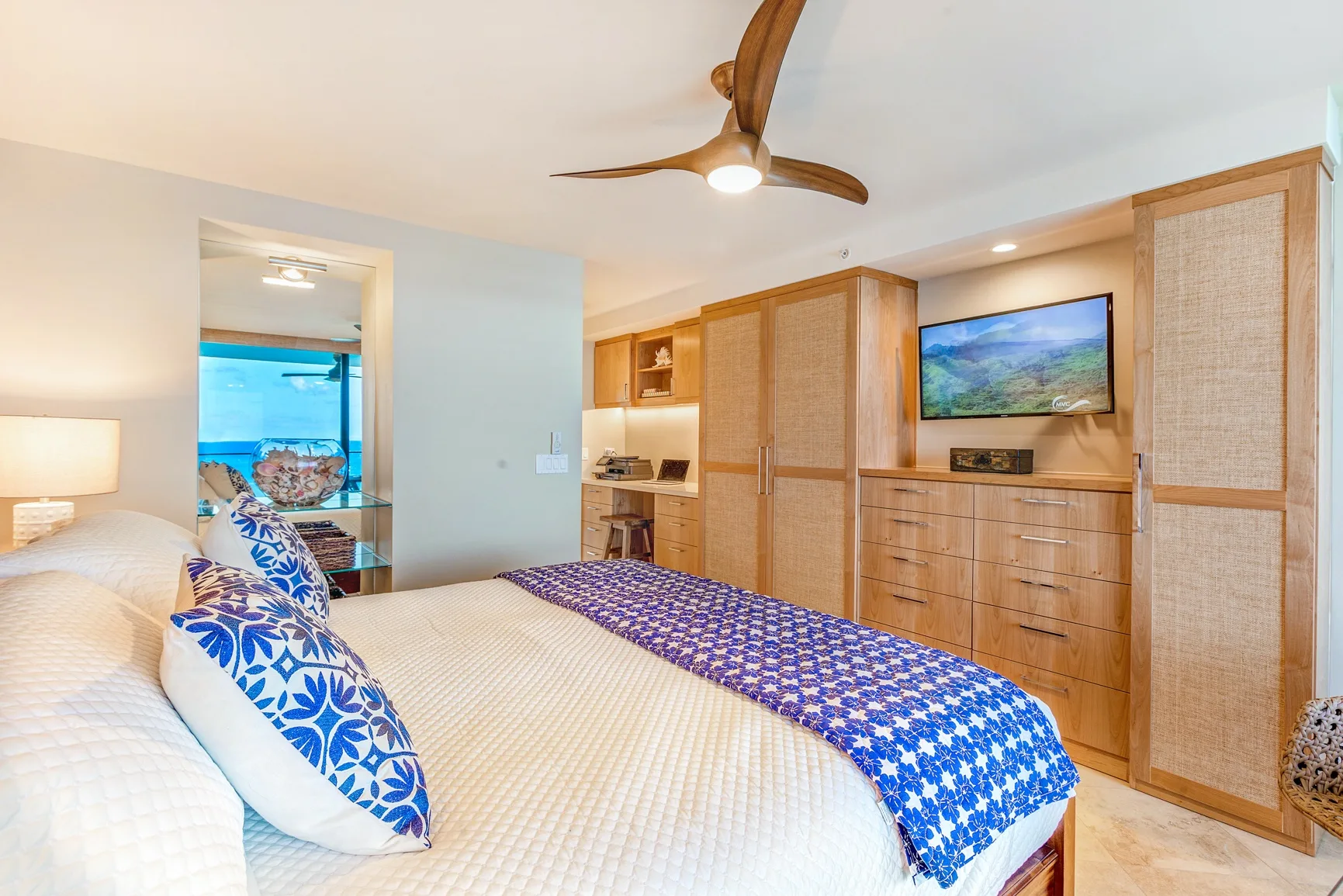 A bedroom with a bed and built-in wooden cabinetry.