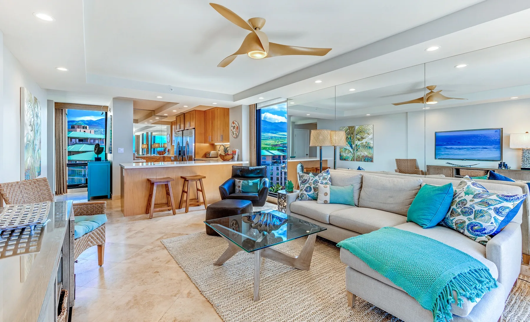 A bright living room with a large sectional sofa and a kitchen bar.