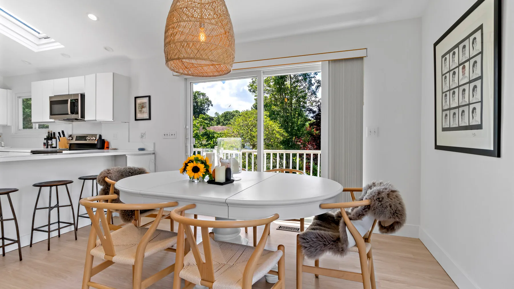A dining area with a round table and chairs beside a sliding glass door.