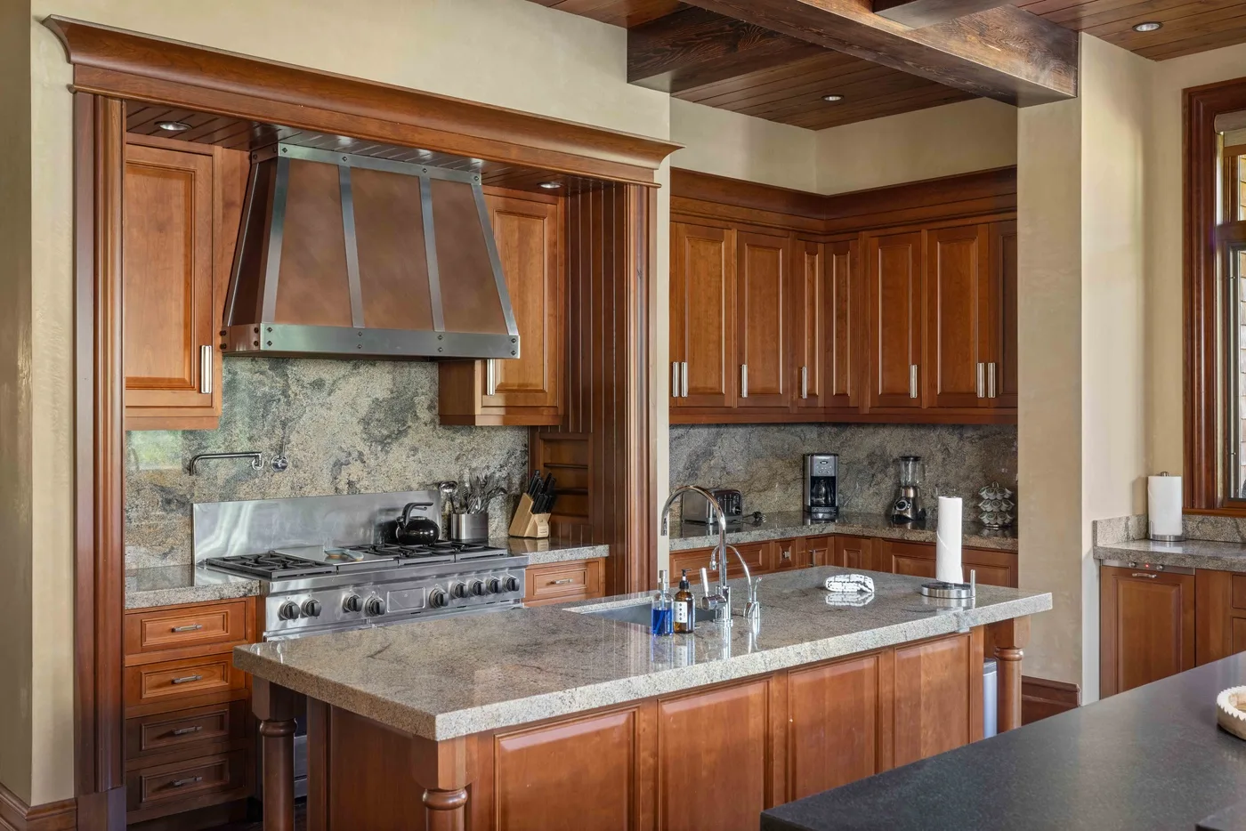 A spacious kitchen with wood cabinets and a central island.