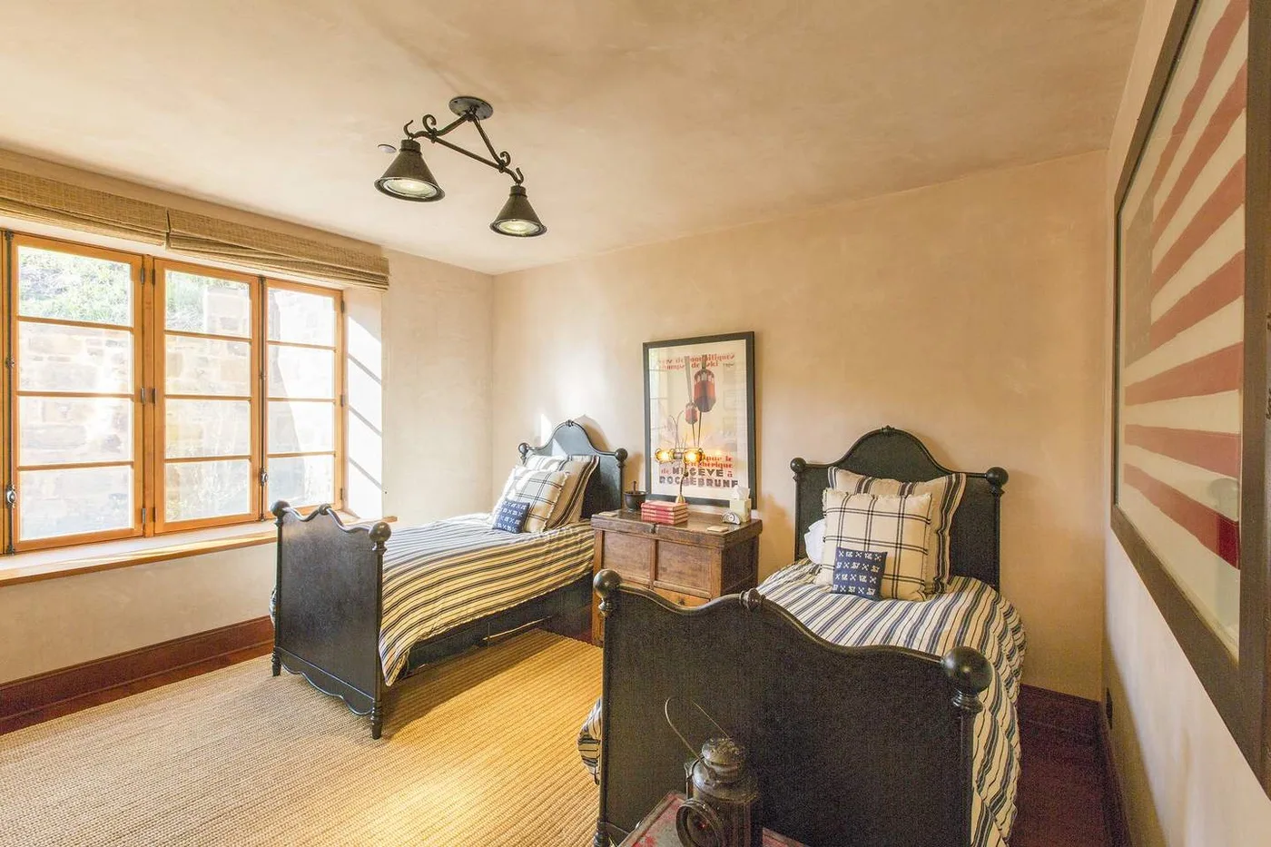 Un dormitorio con dos camas y una ventana grande.