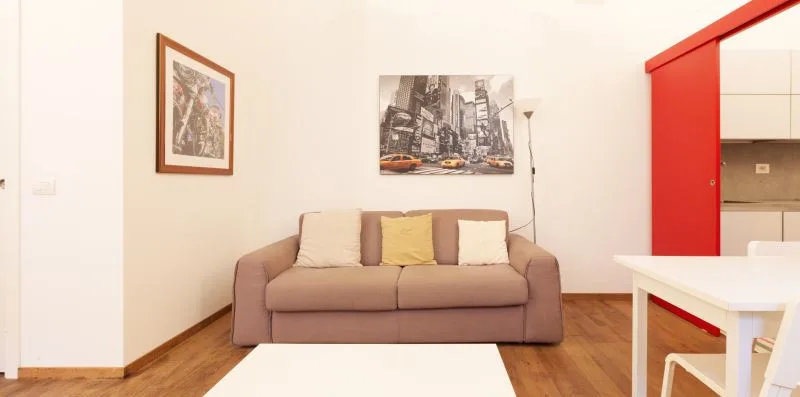 A living area with seating, wall art, and a white table.