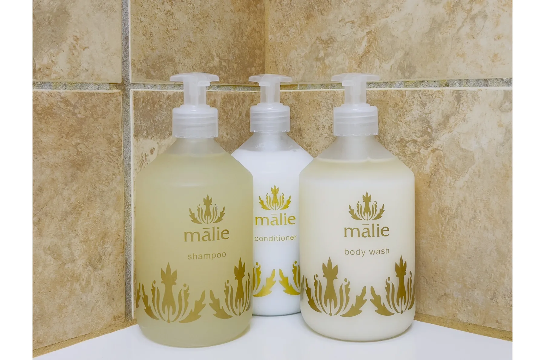 Bathroom toiletries stand against a tiled wall.