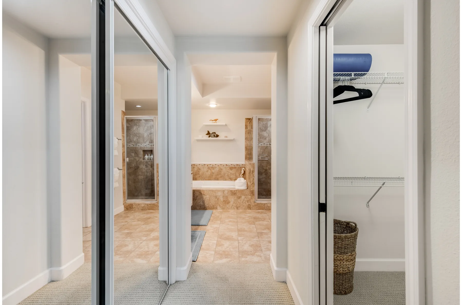 A bathroom with a bathtub is visible through an open doorway.
