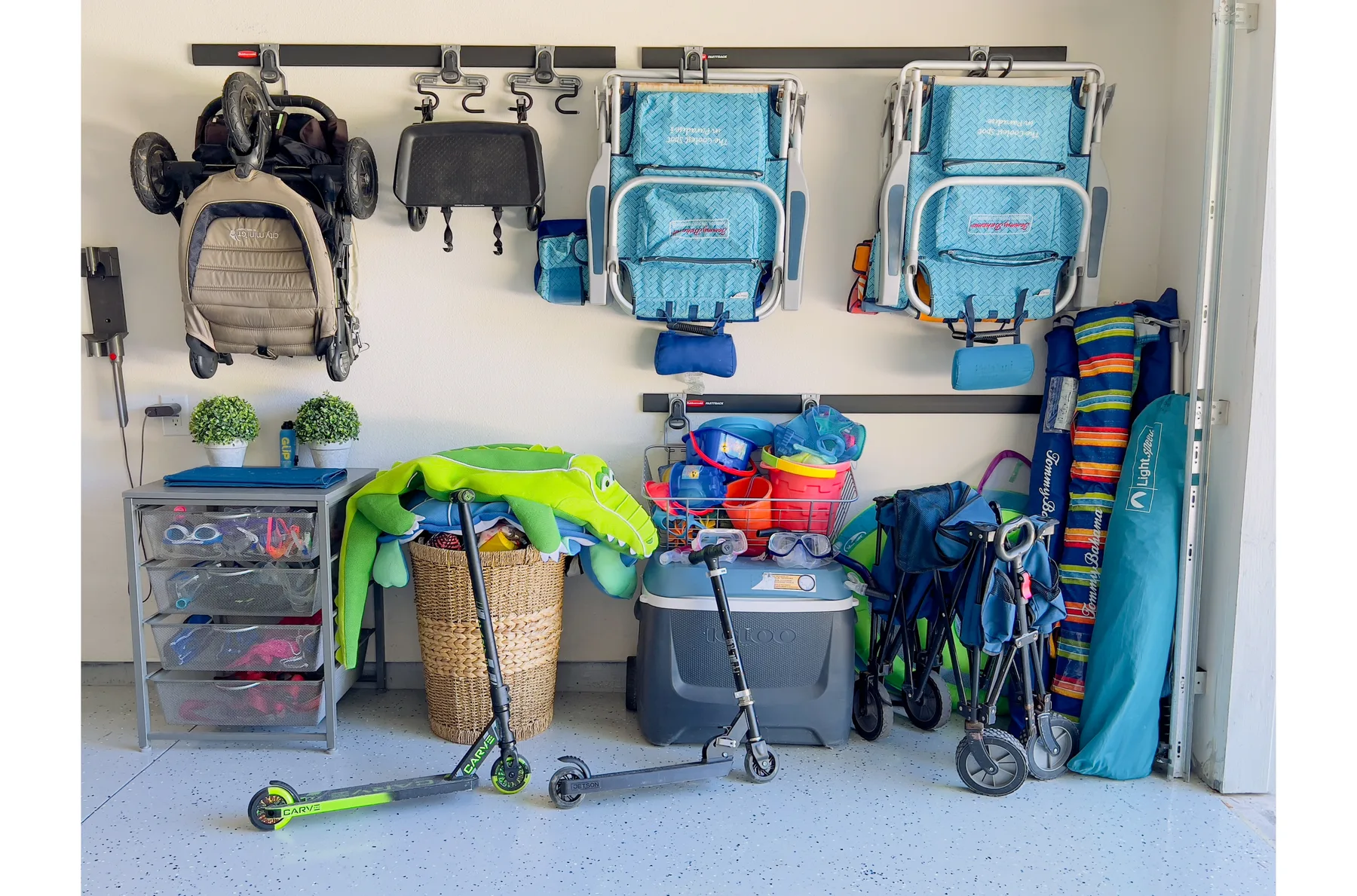 A garage storage area with bicycles, scooters, and outdoor gear.