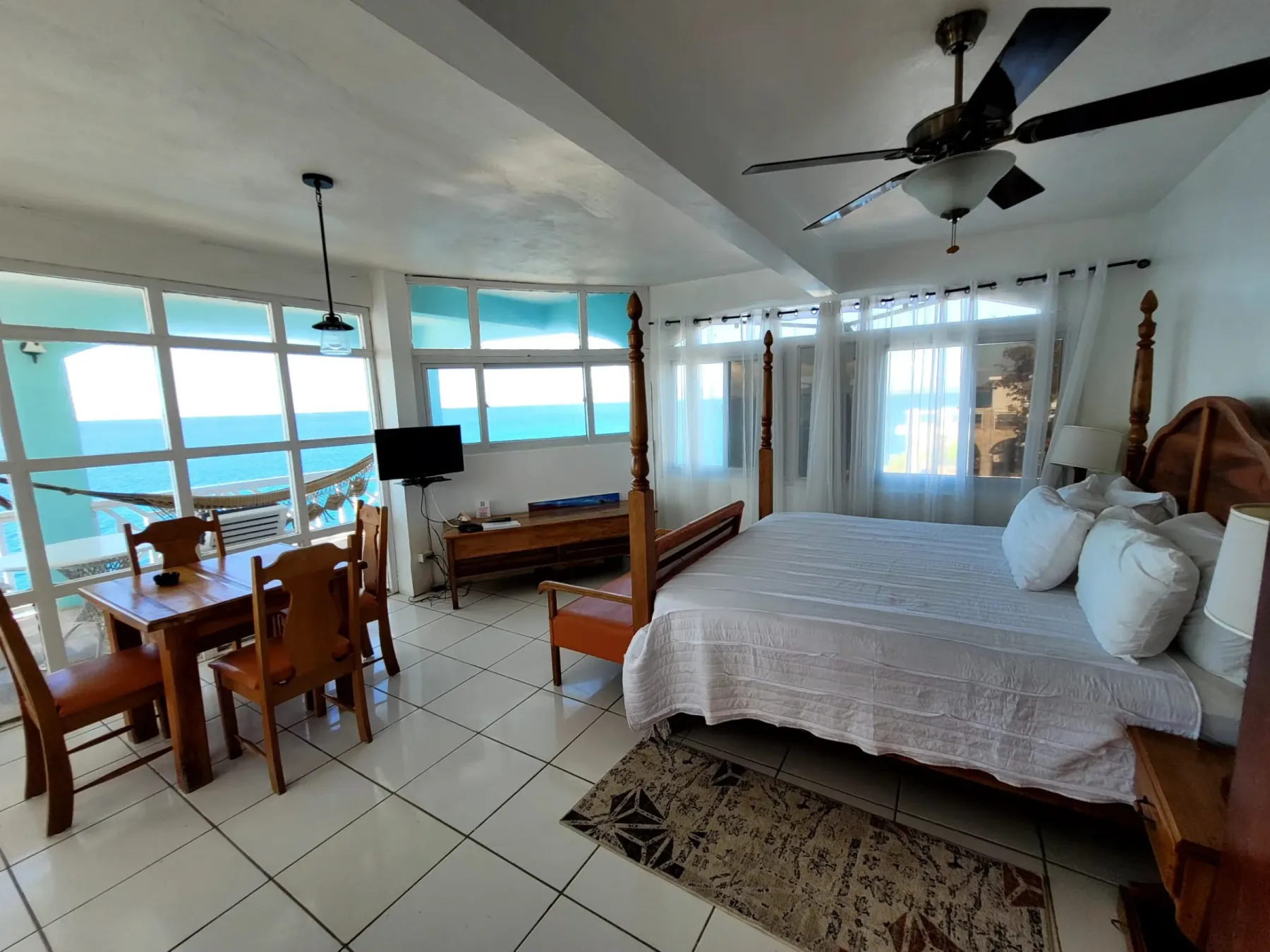 King bed and sea-view windows in the Original Penthouse, Room 12