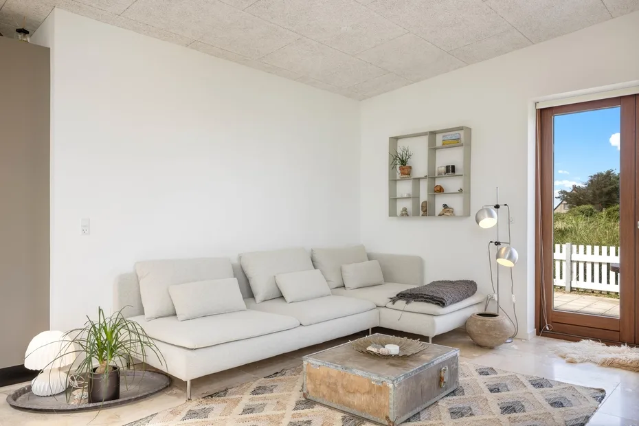 A bright living room with a sectional seating area and a coffee table.