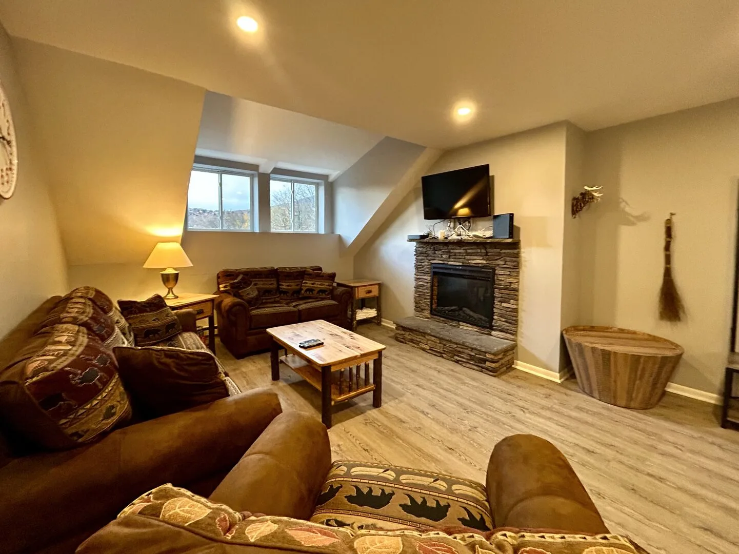 Living room with seating, a coffee table, and a fireplace.