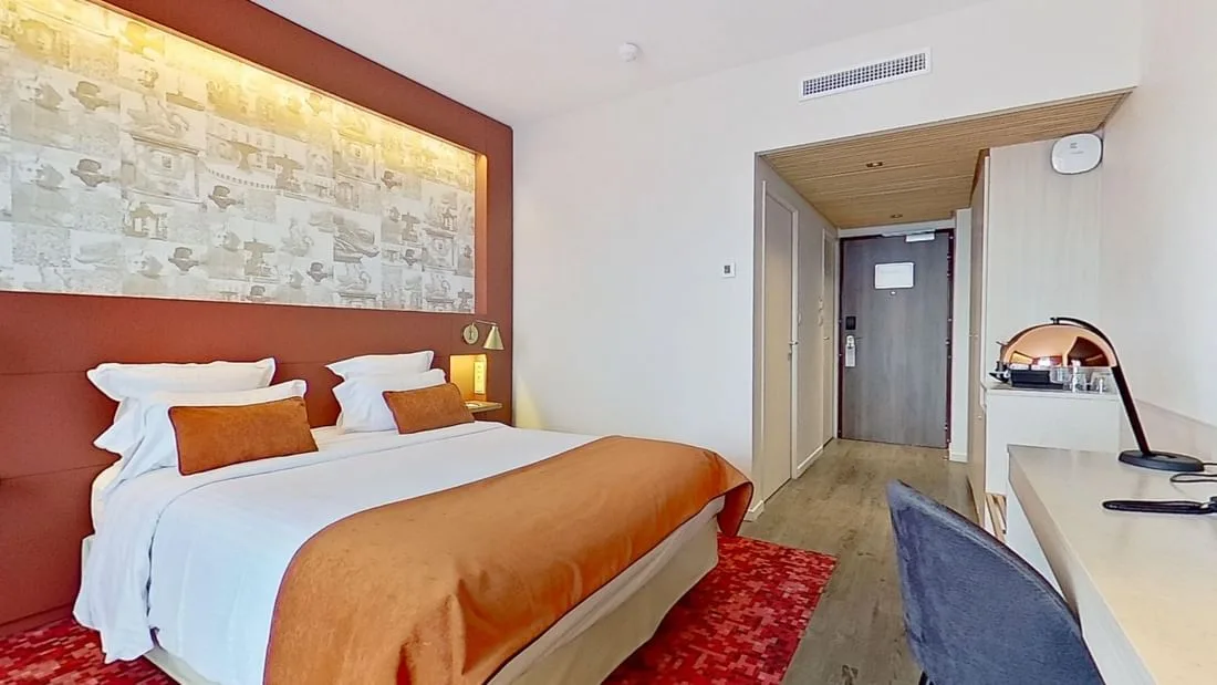 Guest room with large bed and desk