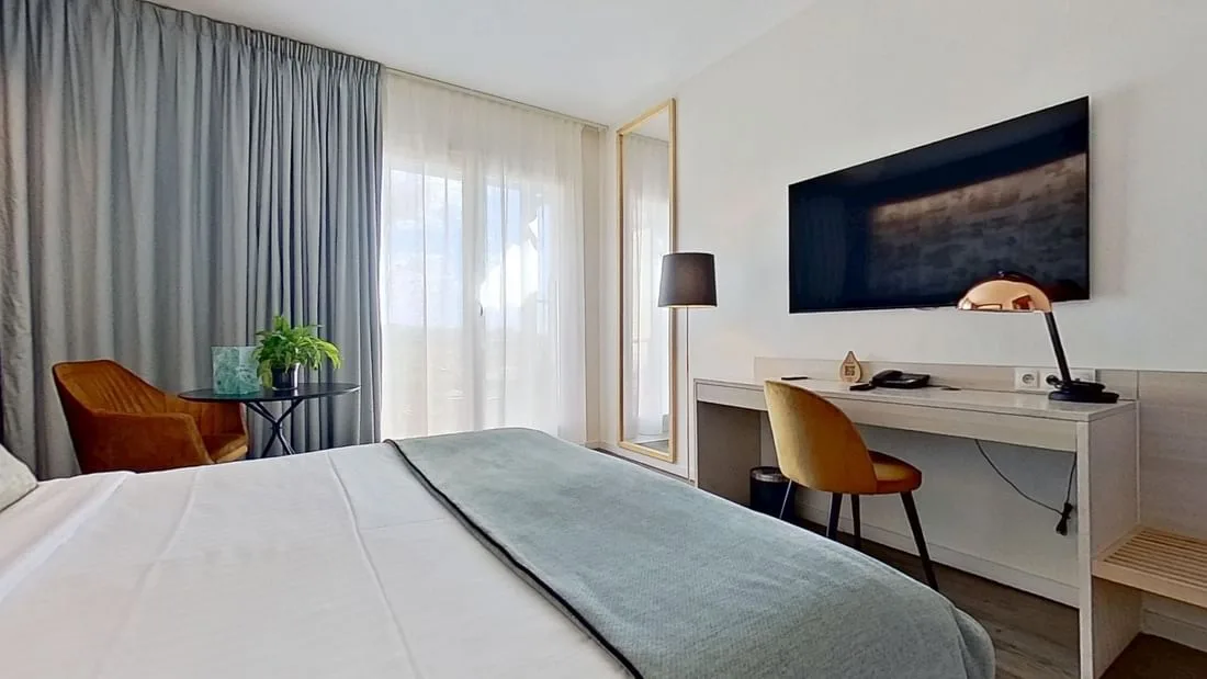 Modern guest room with desk and seating