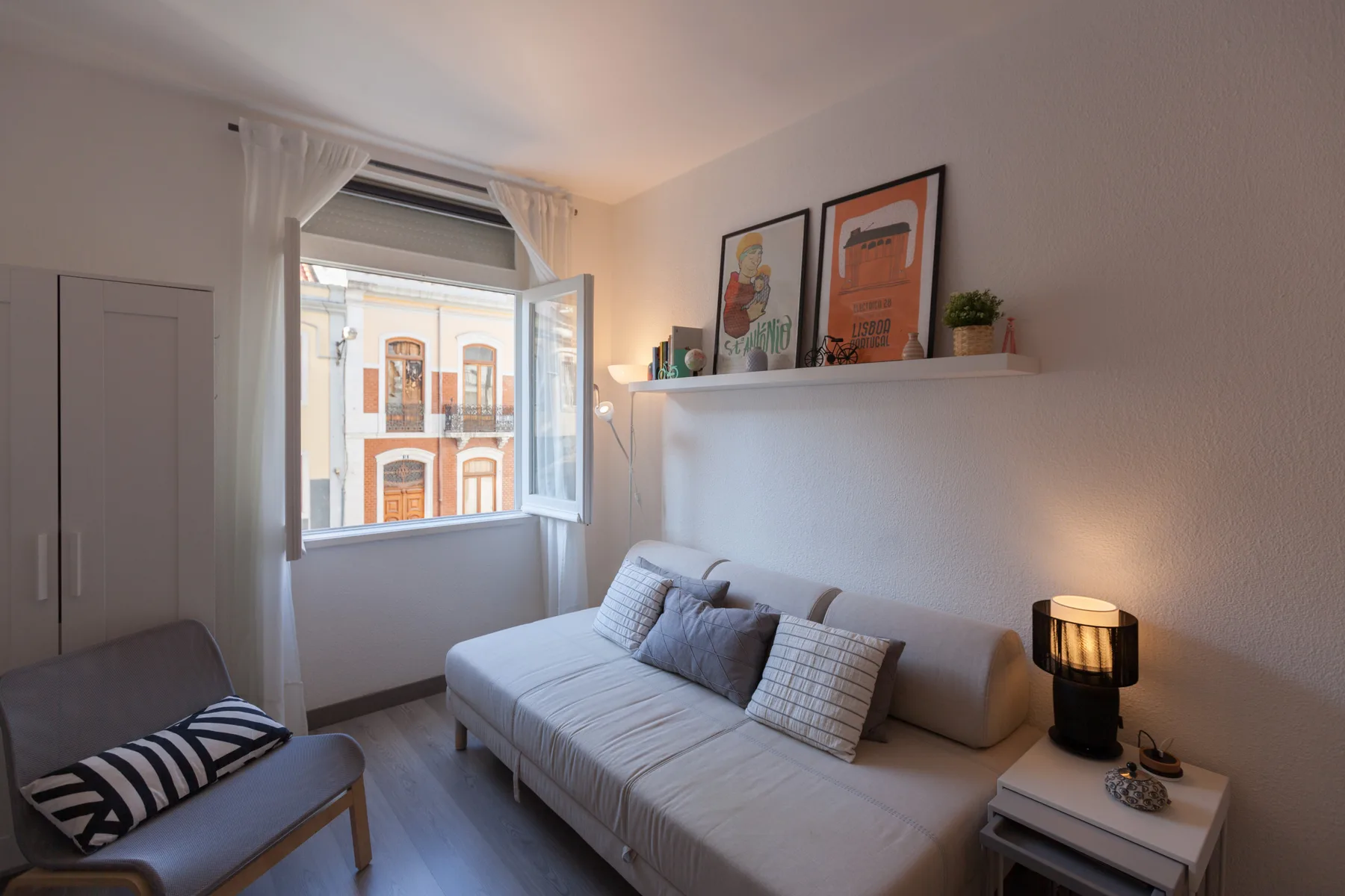 A bright living area with seating beside an open window.