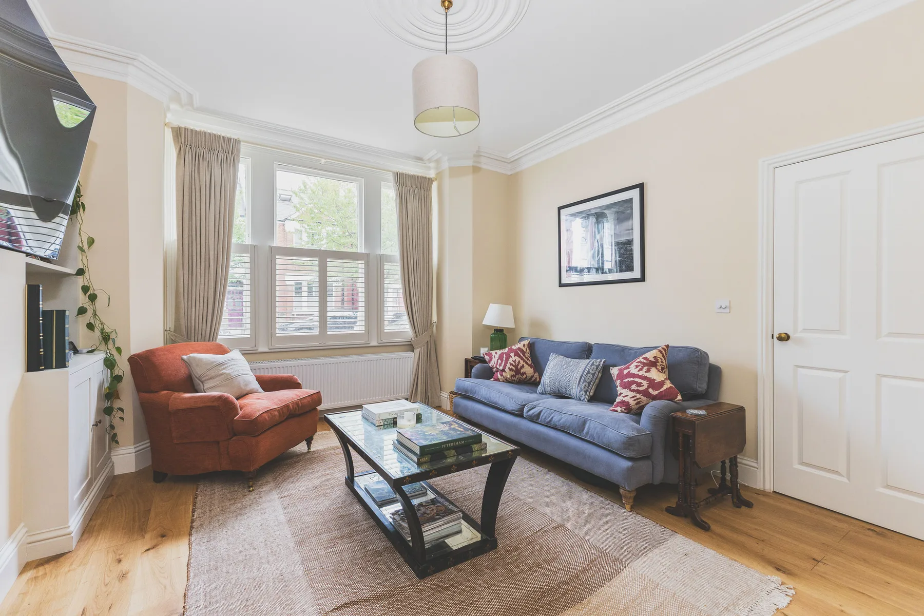 A living room with seating arranged around a glass coffee table.