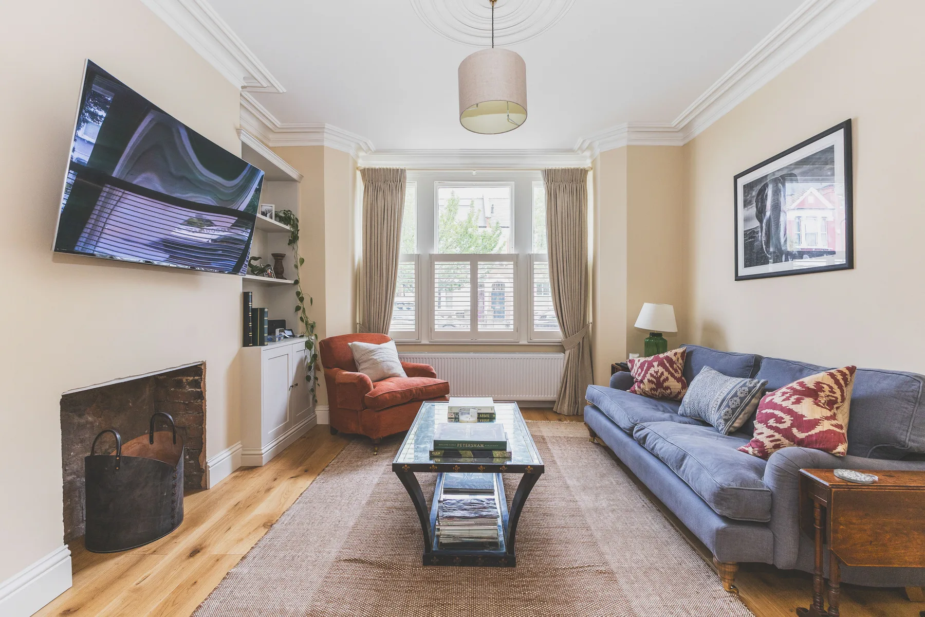 A living room with seating arranged around a glass coffee table.