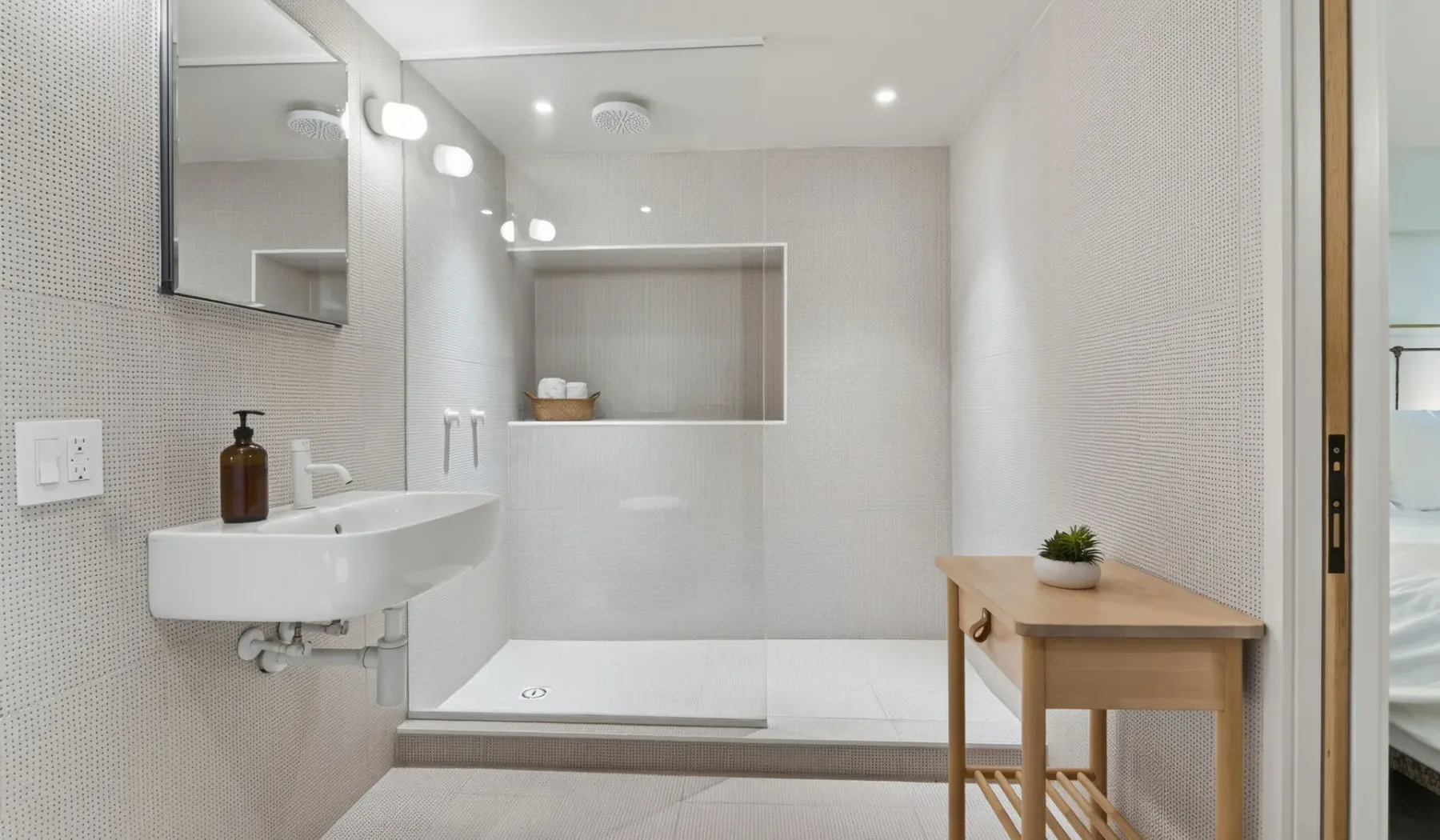 Un baño luminoso con lavabo, bañera y una pequeña mesa de madera.