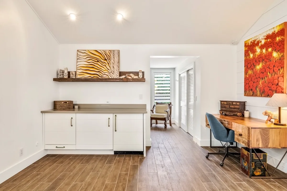 Una luminosa zona de comedor y trabajo cuenta con una mesa de madera y armarios empotrados.