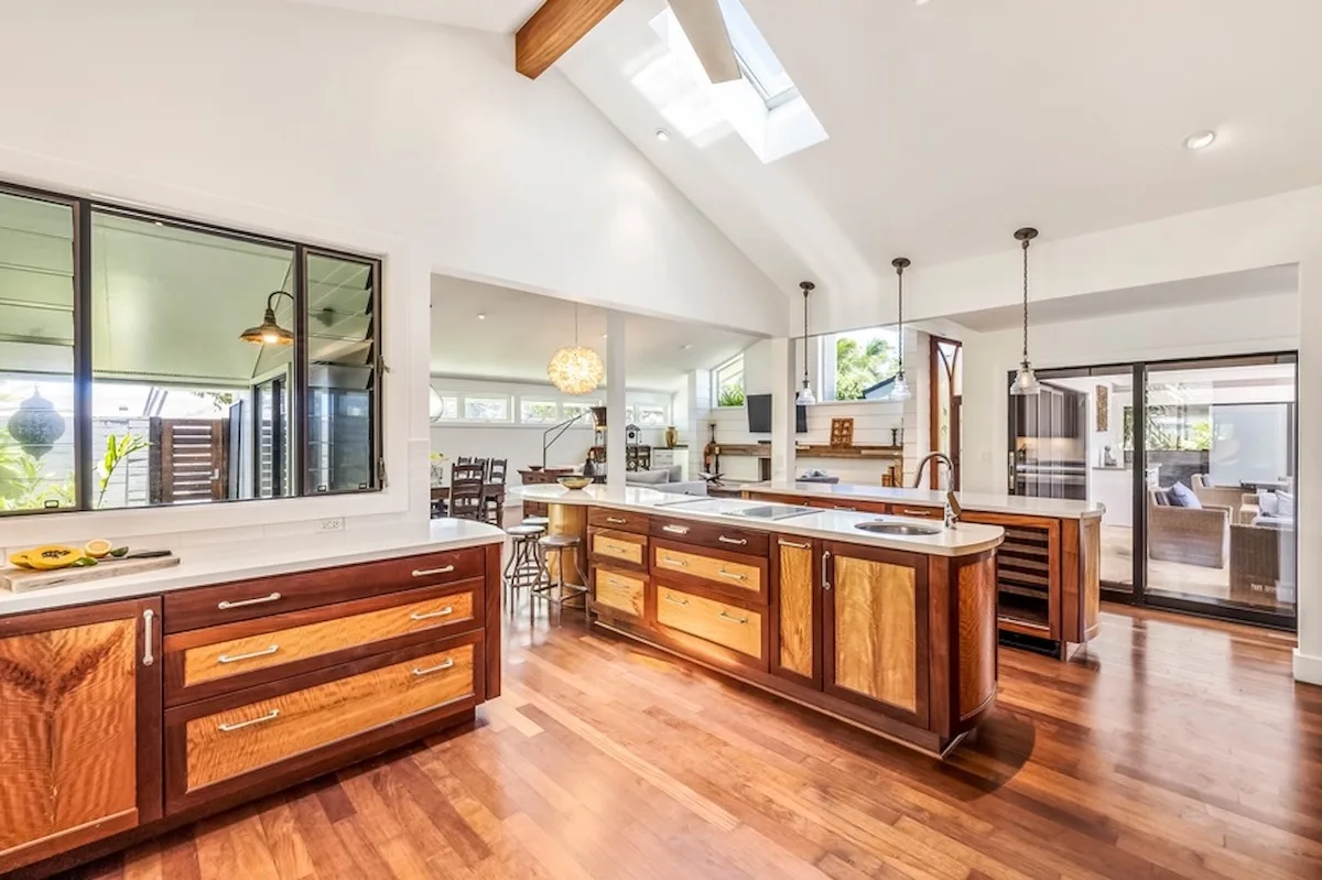 Una cocina amplia con una gran isla central y gabinetes de madera.