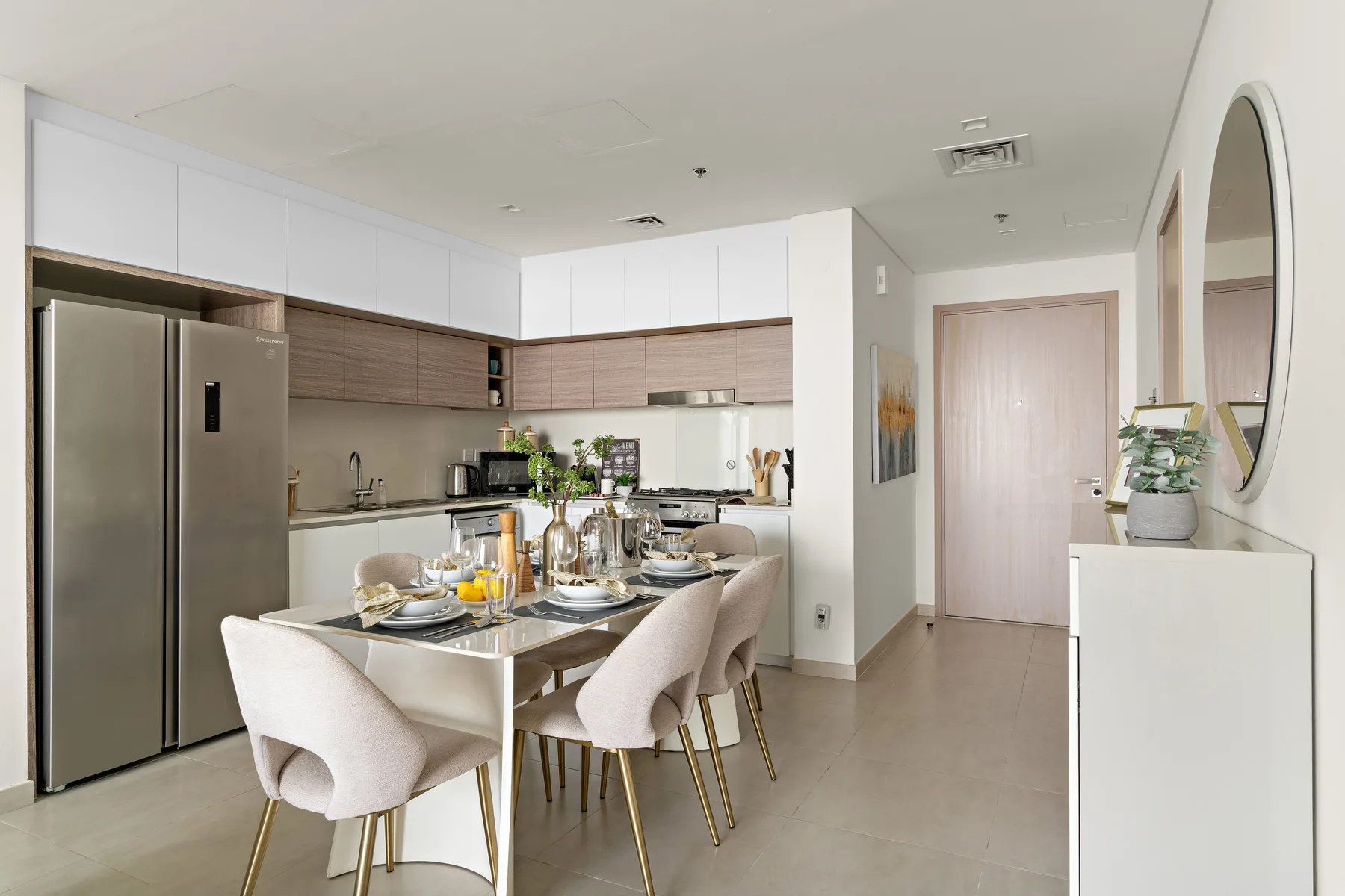 A modern kitchen and dining area with a table set beside the counter.