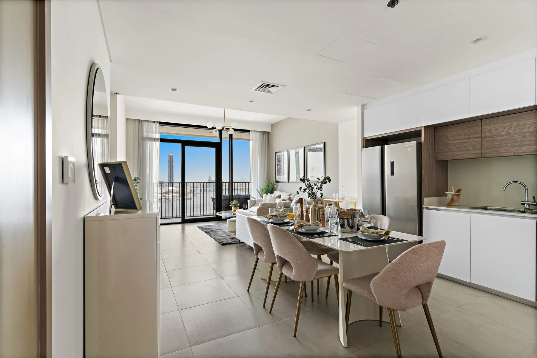 An open-plan dining area and kitchen, with a table beside the living space.