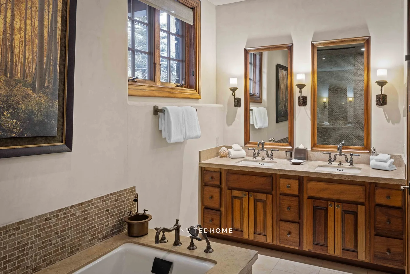 A bathroom vanity with two mirrors, a sink, and wooden cabinetry.