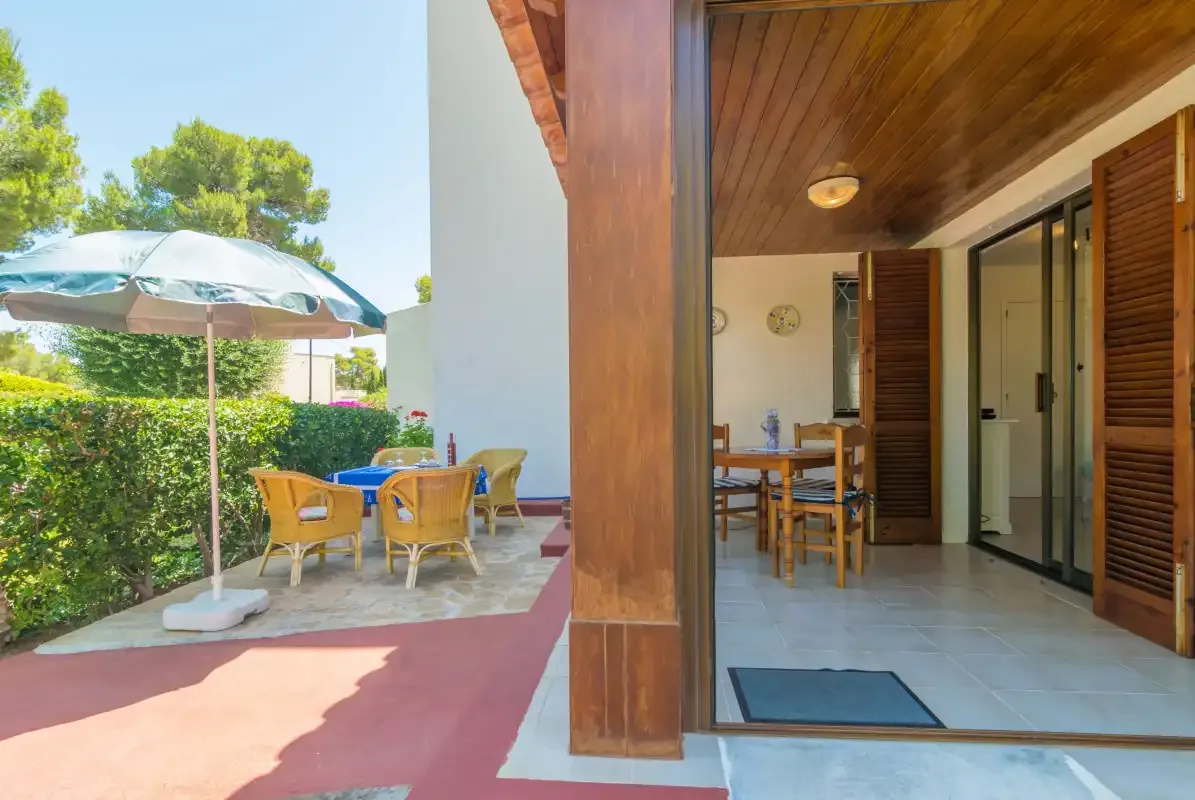 A covered patio with outdoor seating and a dining area.