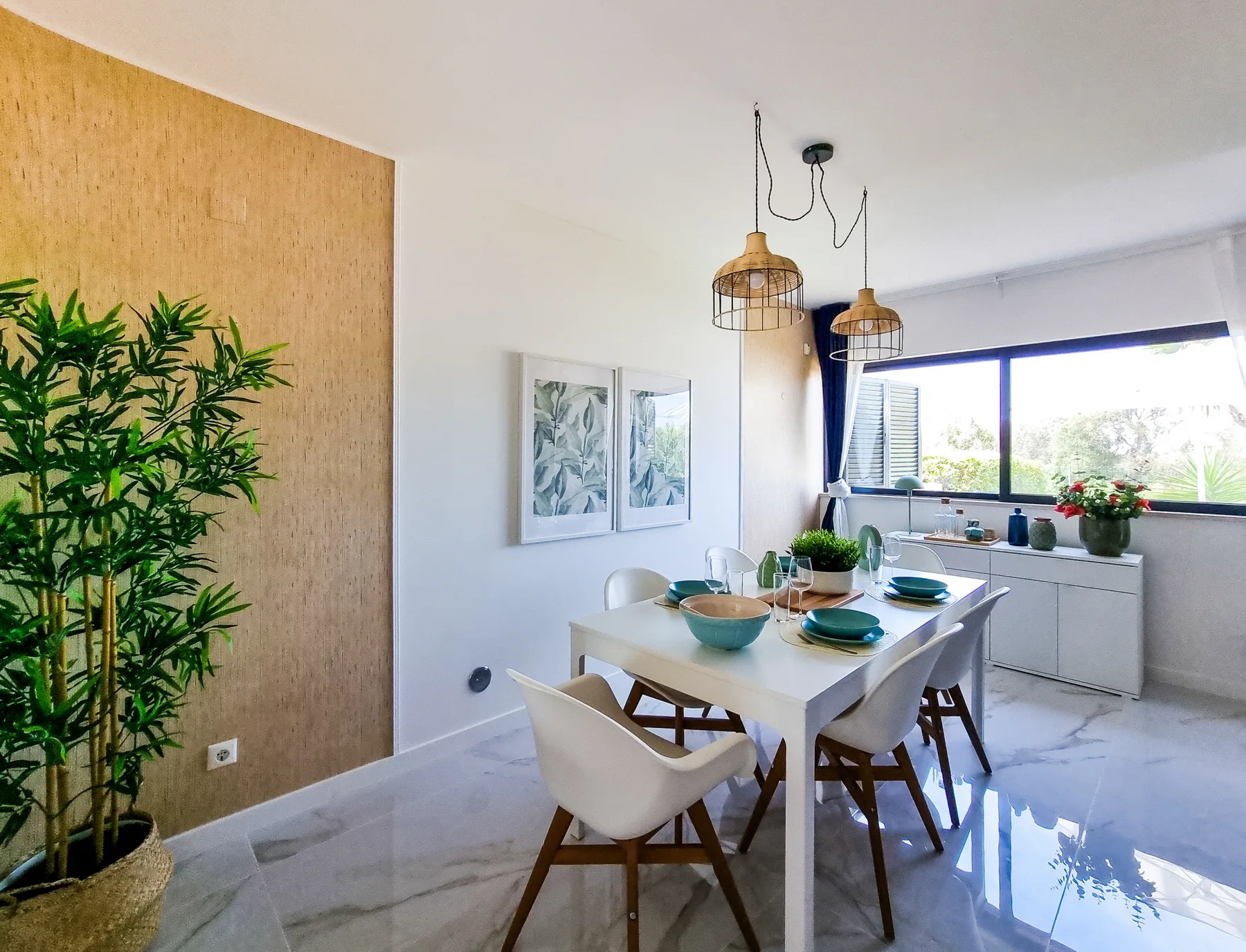 A bright dining area with a set table beside a wide window.