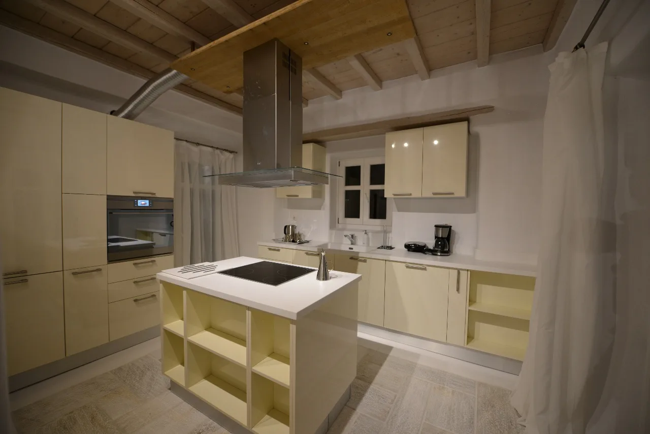 A bright kitchen with pale cabinetry and a central island.