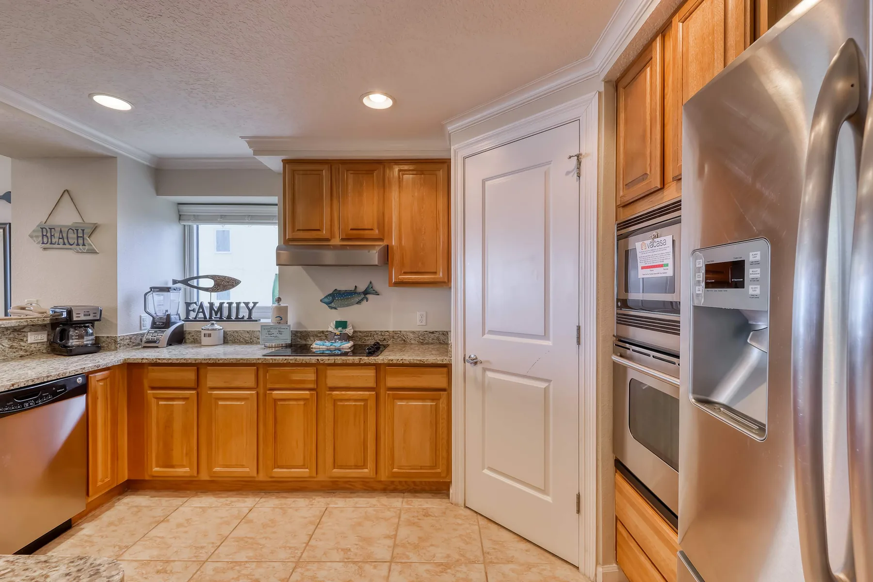 A kitchen with wooden cabinets, a countertop, and stainless steel appliances.