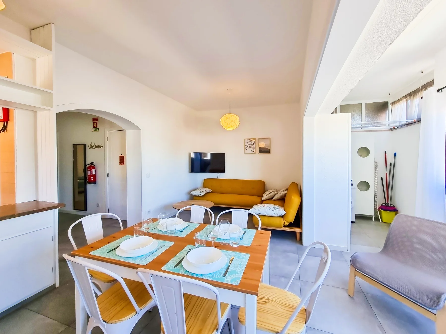 A bright living and dining area with a table and seating.