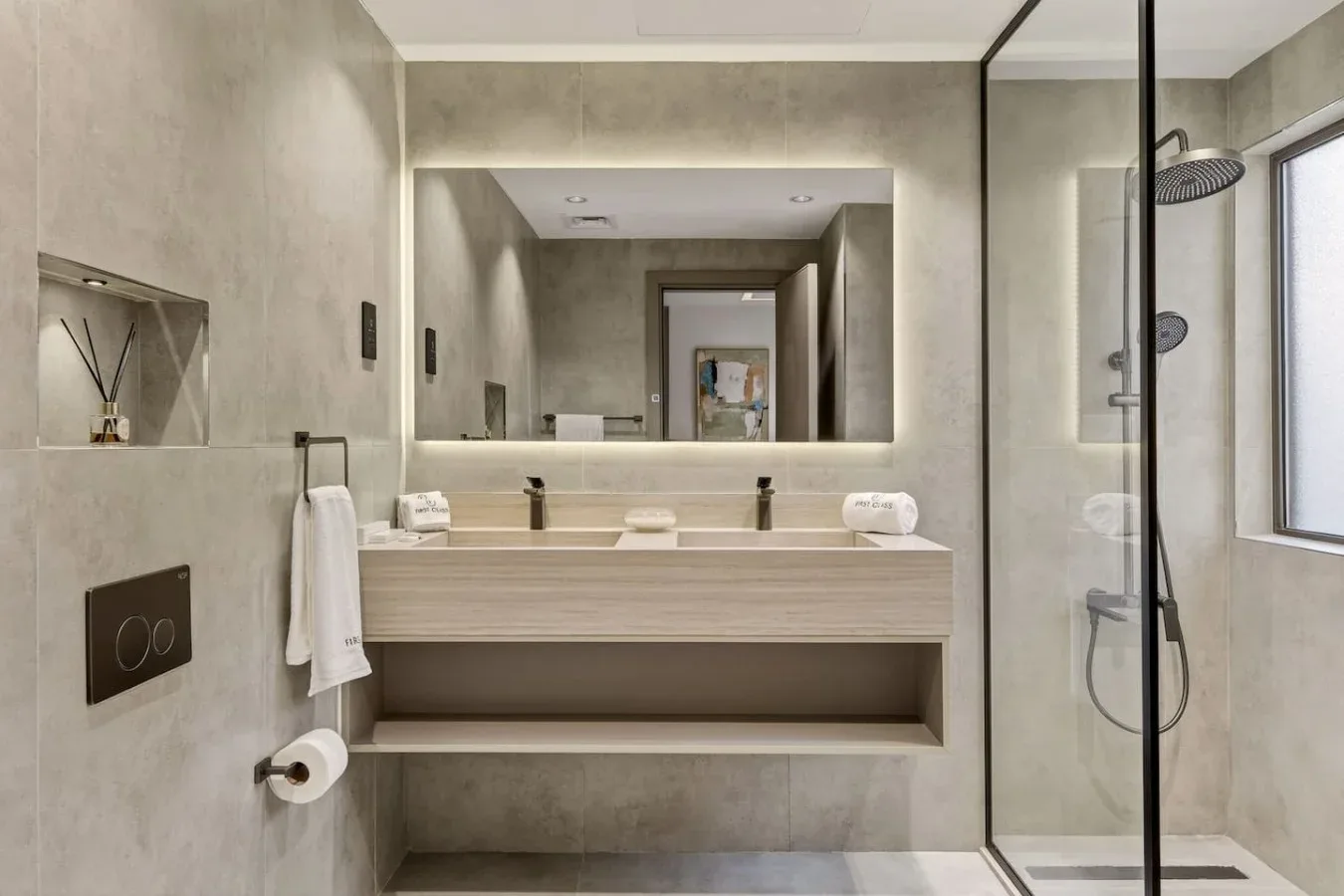 A modern bathroom with a wide vanity and glass shower.