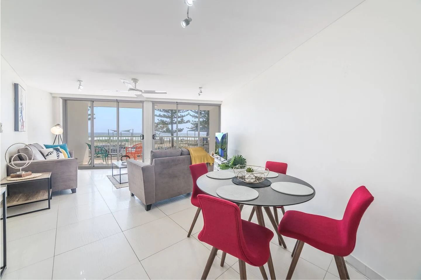 Open plan living area lets in loads of light and is complete with a dining table to comfortably fit four people
