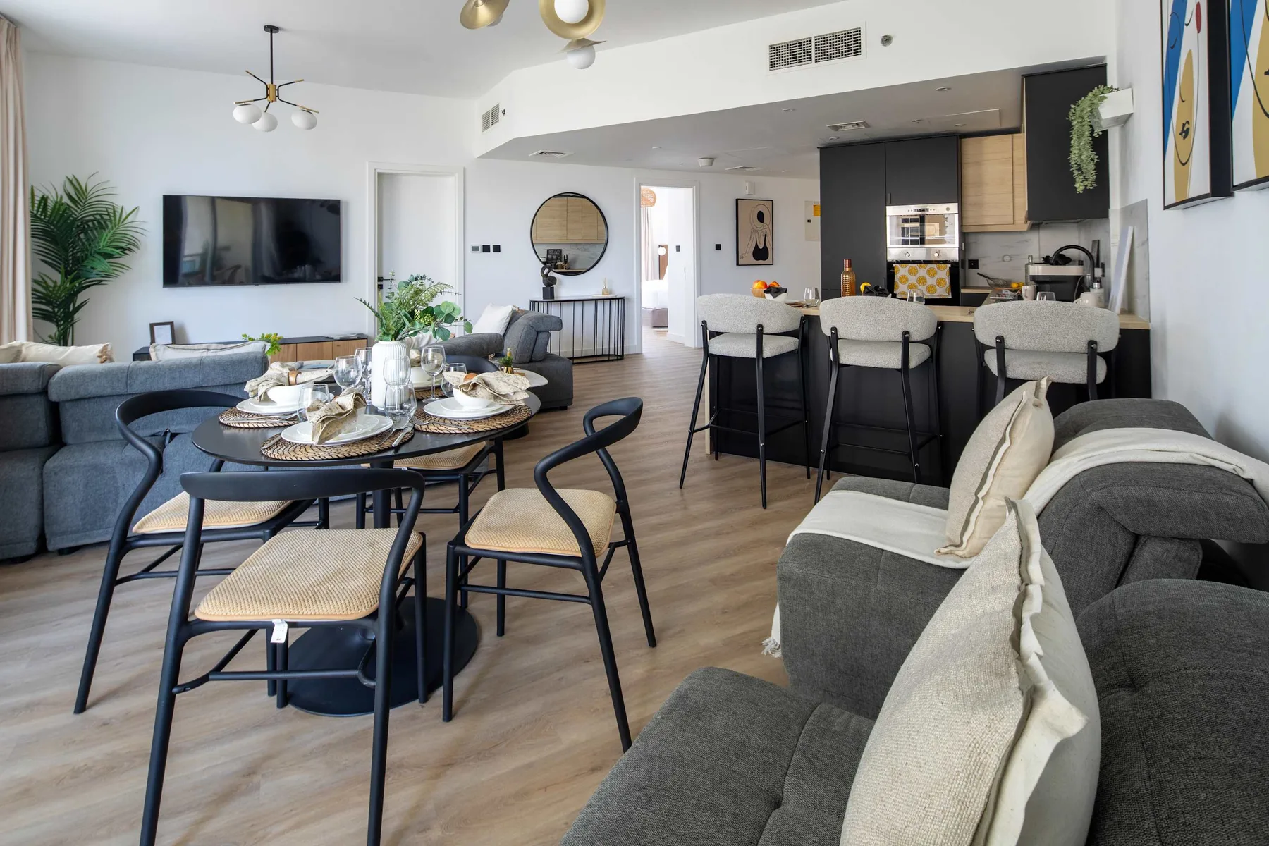 An open-plan living and dining area with a kitchen island and bar seating.