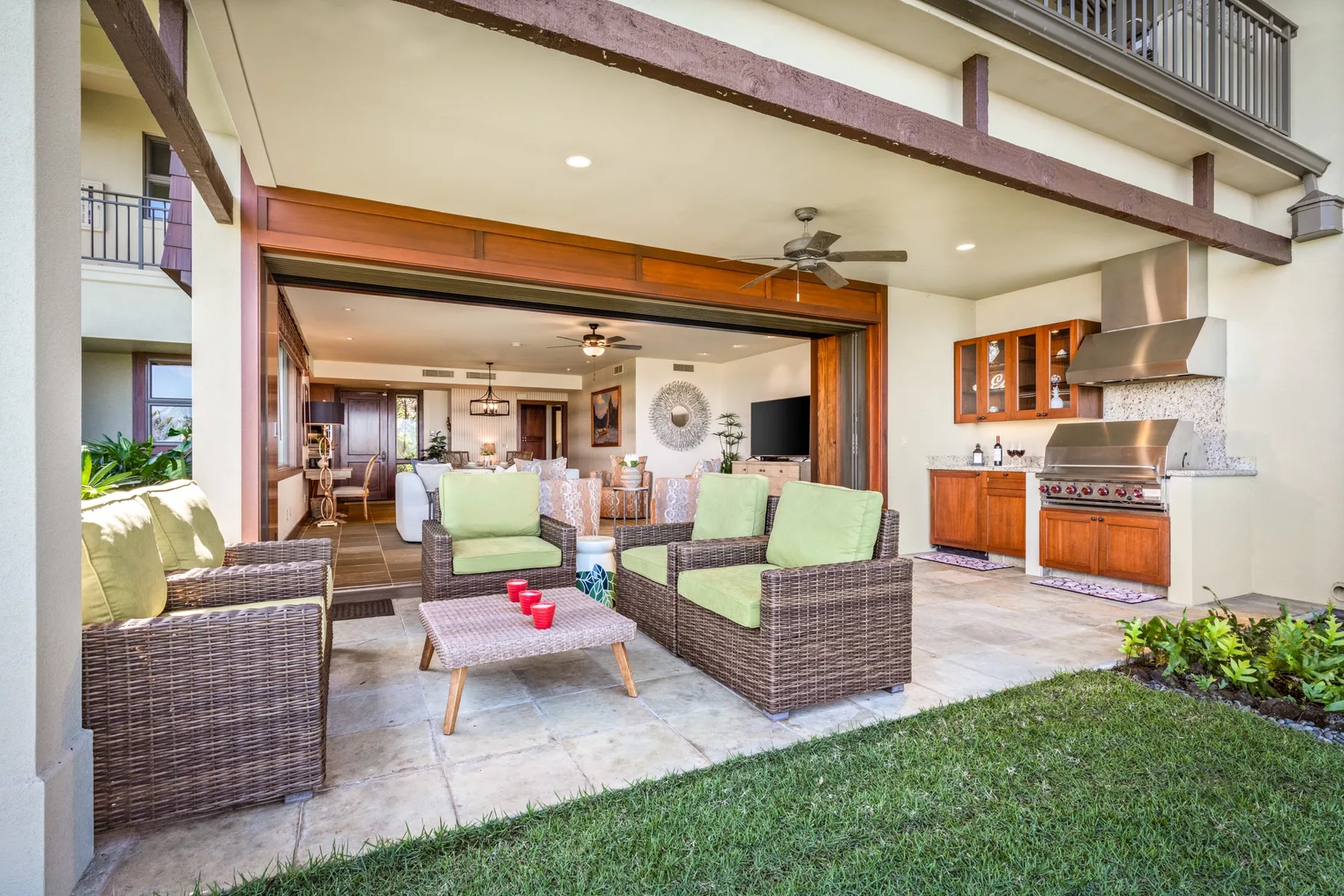An open patio seating area with a dining space and kitchen beyond.