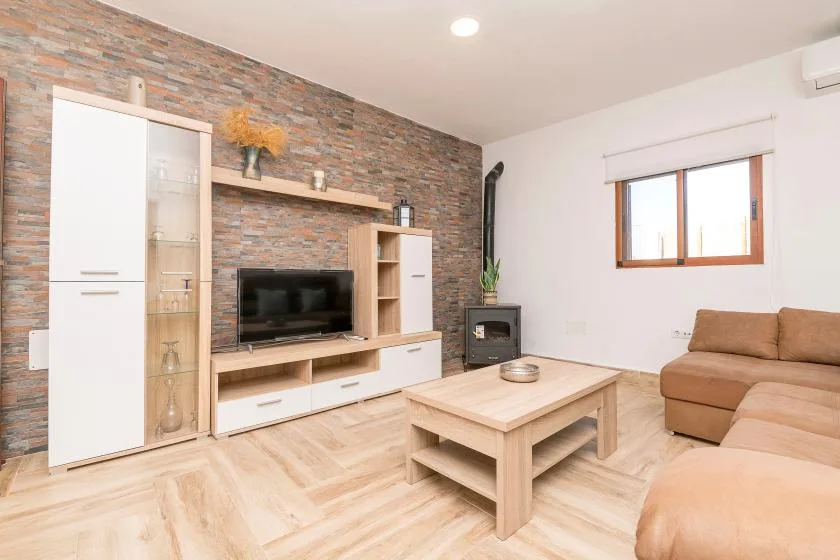 A living room with a television, coffee table, and seating.