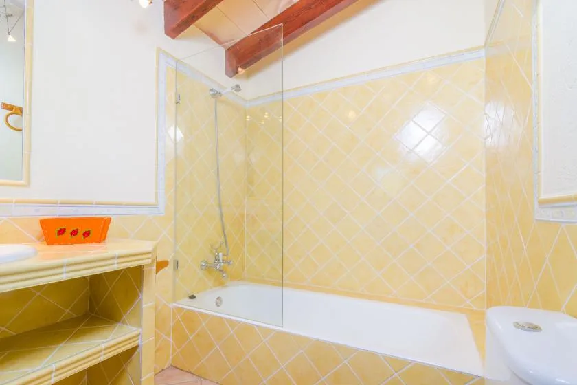 A tiled bathroom with a bathtub and shower.