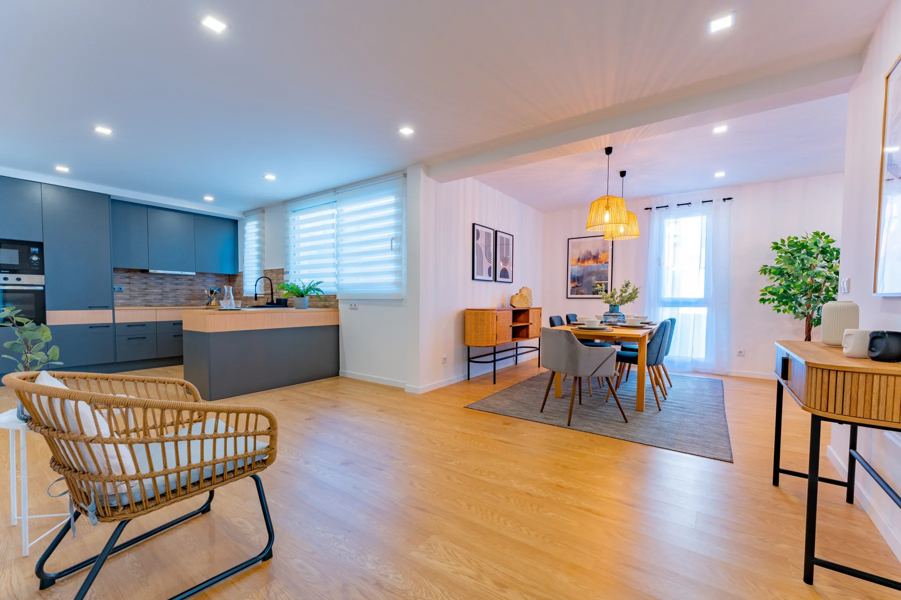 Open-plan living and dining area with a kitchen and dining table.