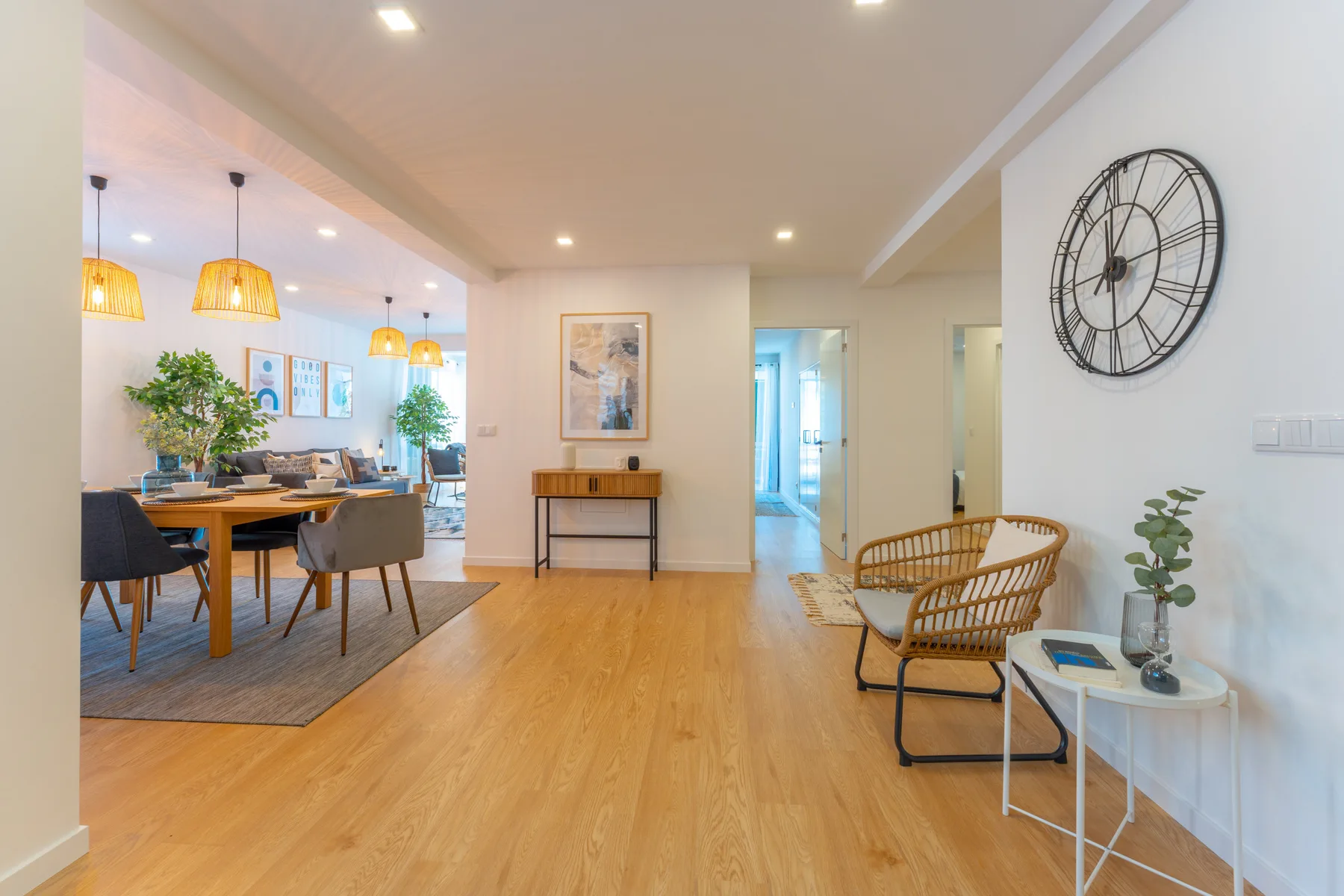 An open-plan living and dining area with seating and a wooden floor.
