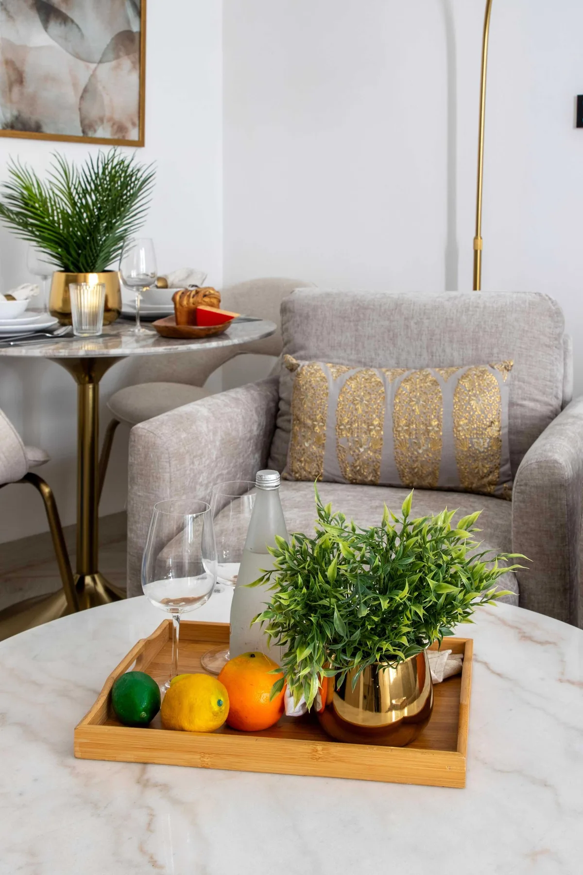 A living room seating area with a coffee table and decorative plants.