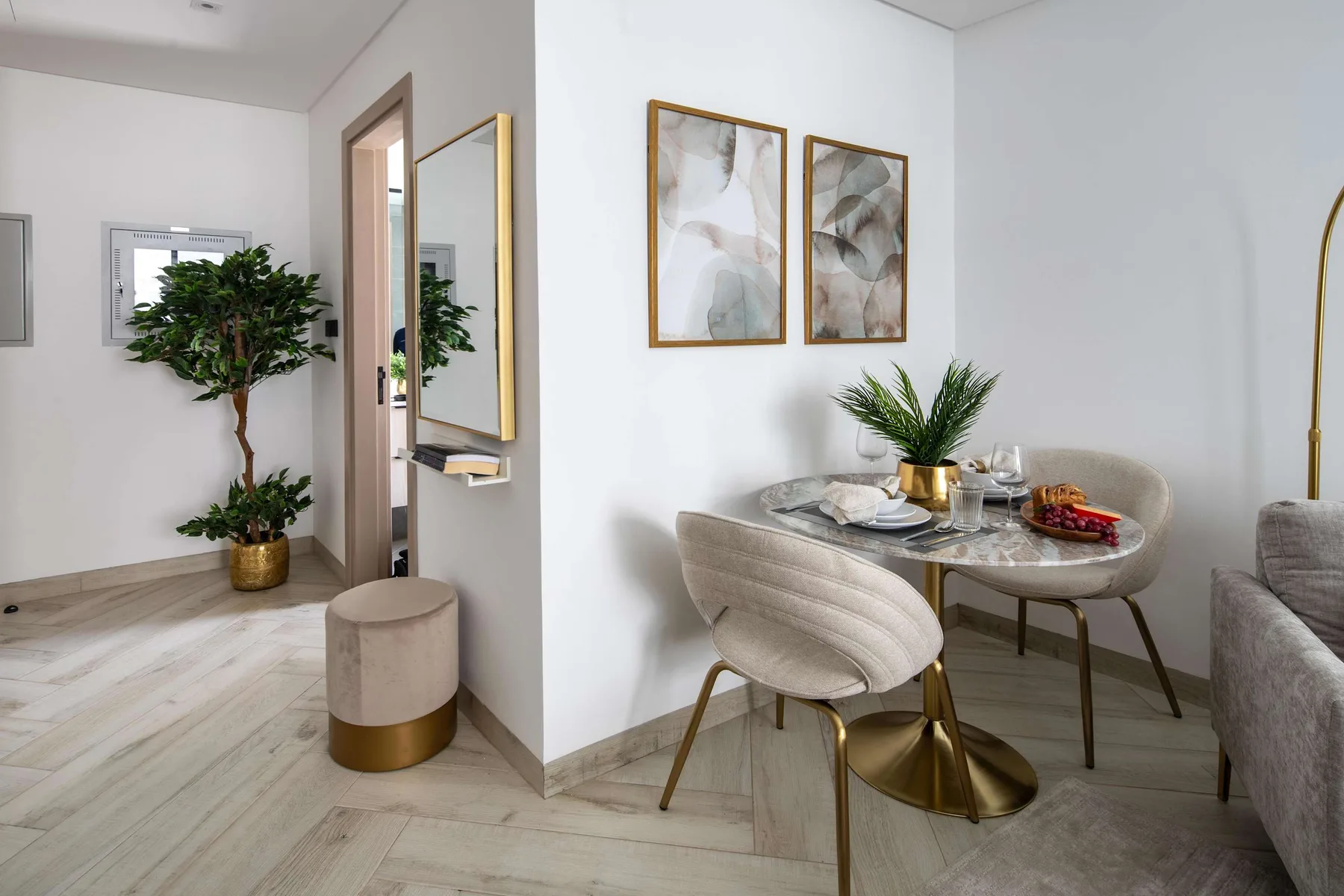 A bright dining area with a set table beside a small entryway.