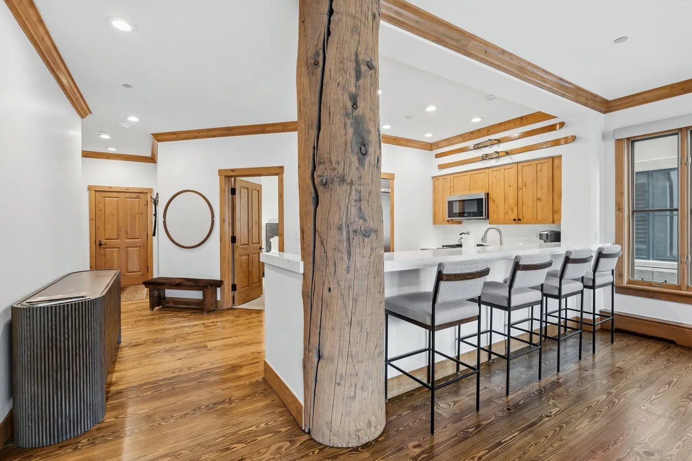 An open kitchen and dining area with a long counter and wood cabinetry.