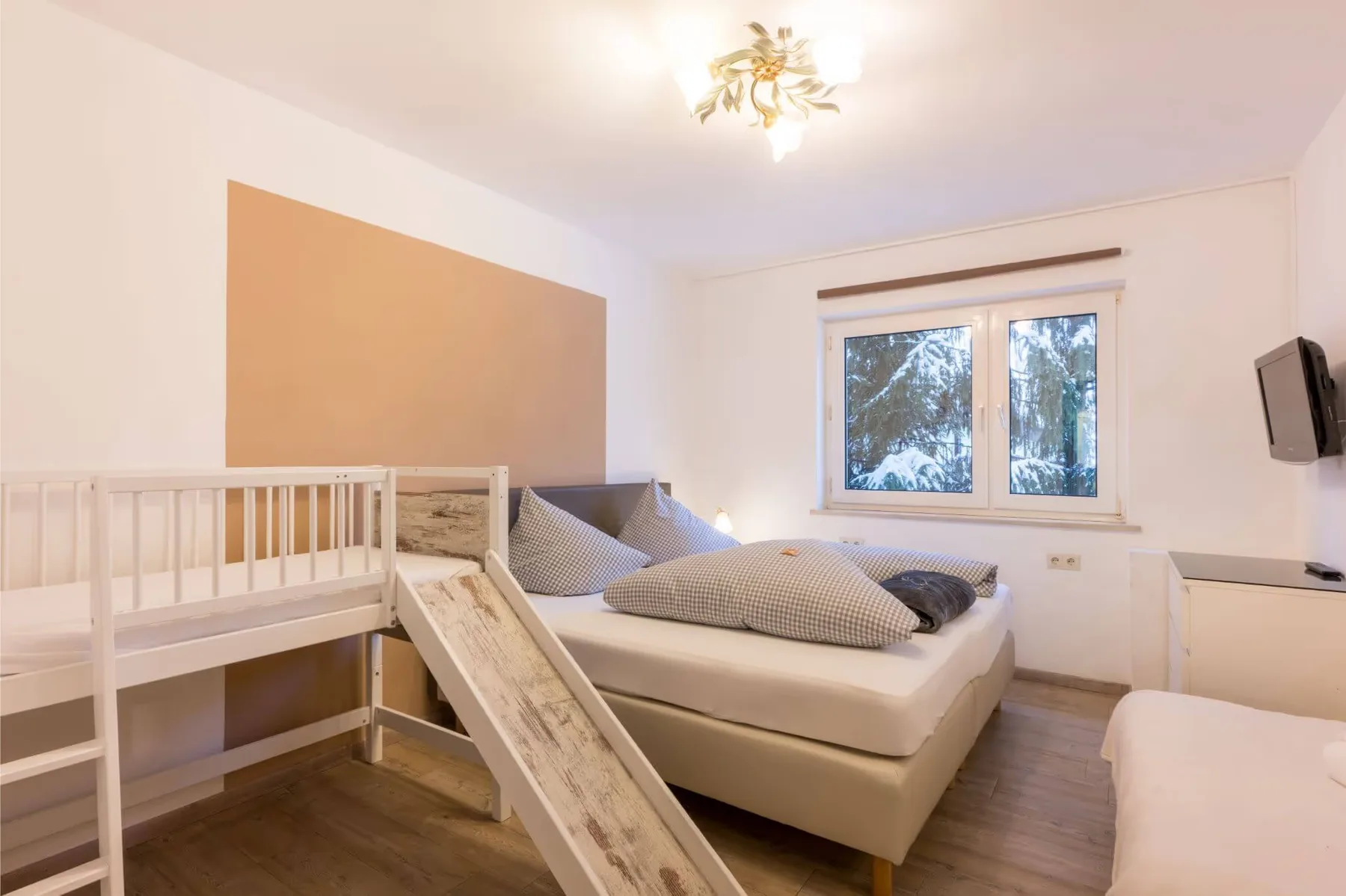 Holiday apartment bedroom with an additional child’s bed