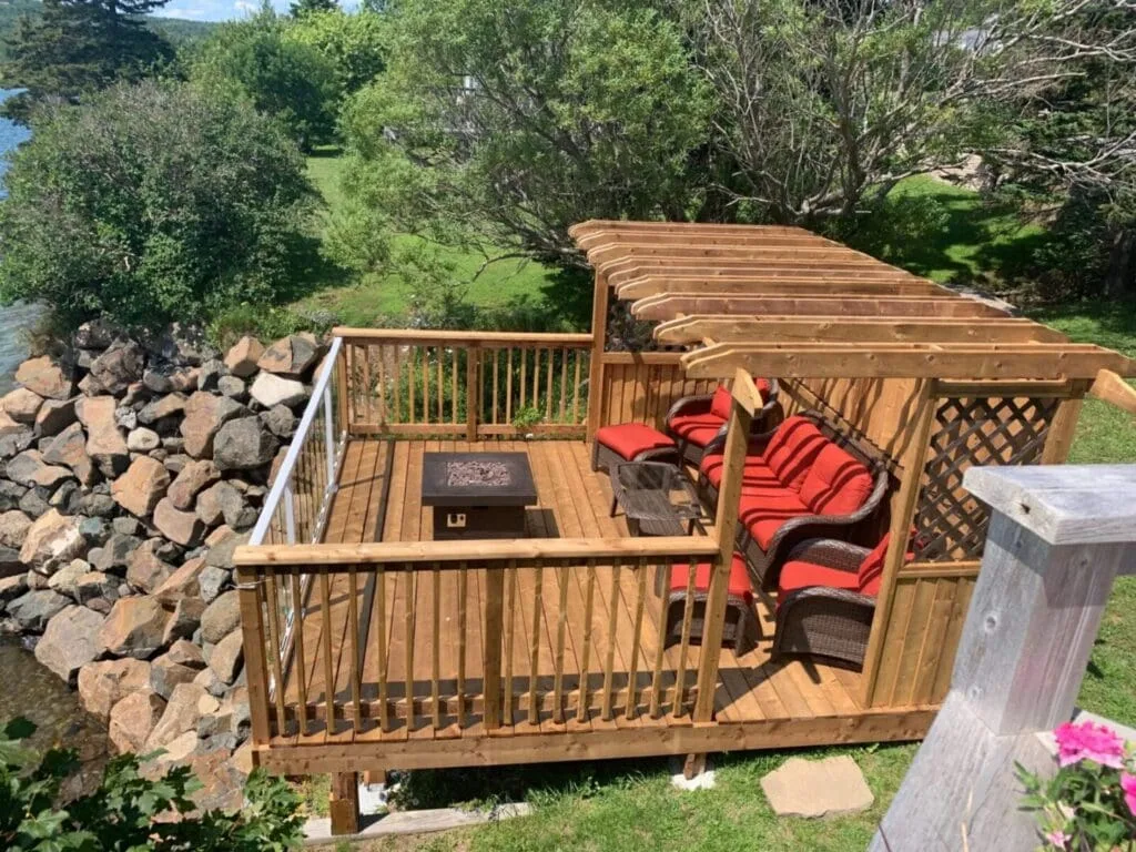 Deck with red-cushioned chairs.