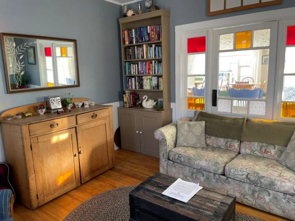 Living room with a colorful window.