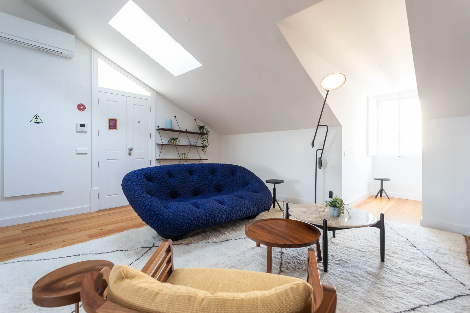 A bright living room with blue seating and a coffee table.