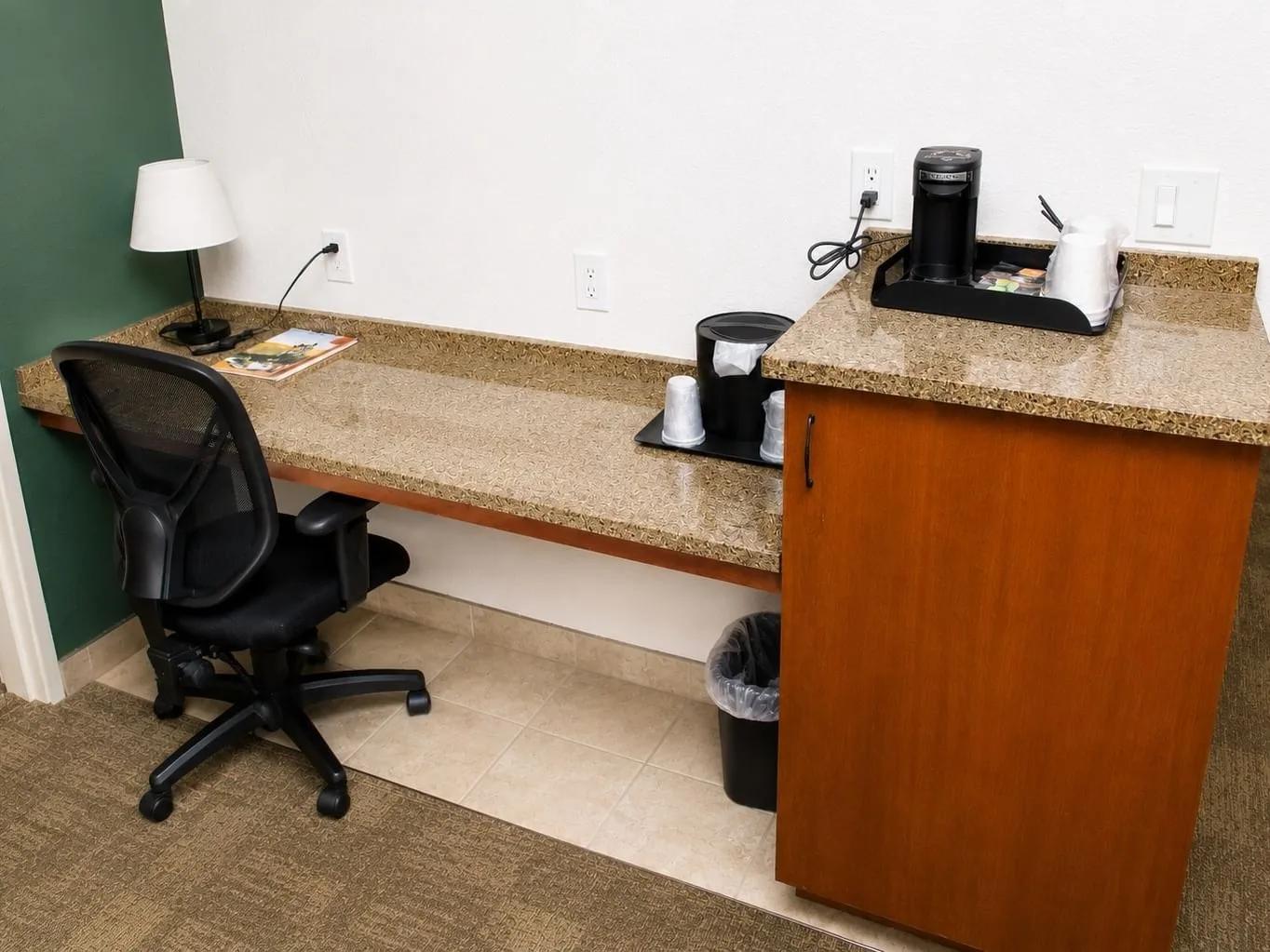 Family Suite workspace with granite countertop, office chair, lamp, and coffee maker