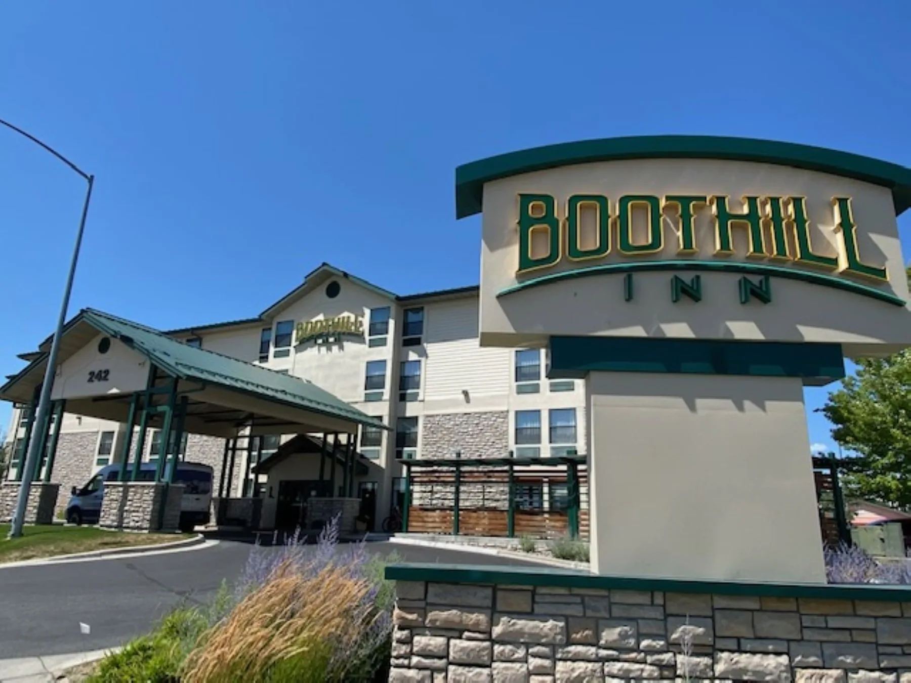 Exterior view of the hotel with monument sign at Boothill Inn & Suites